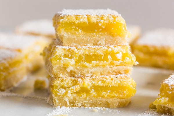 Homemade Lemon Bars stacked on top of each other. 