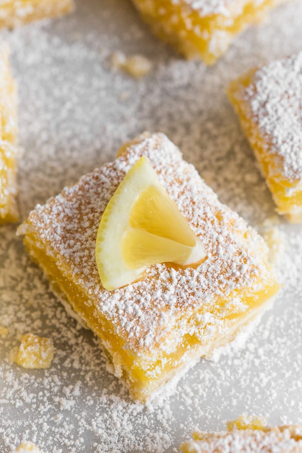 These sweet homemade lemon bars are perfect for spring. Full of tart lemon flavor and made with a sweet shortbread crust. Always a crowd pleaser and delicious for snacking.