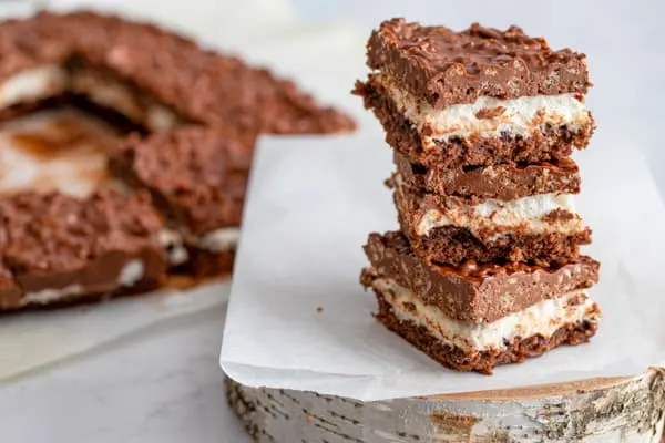 Peanut Butter Marshmallow Krispie Topped Brownies stacked on top of each other. 