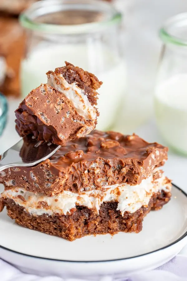 Peanut Butter Marshmallow Krispie Topped Brownies on a plate with a fork. 