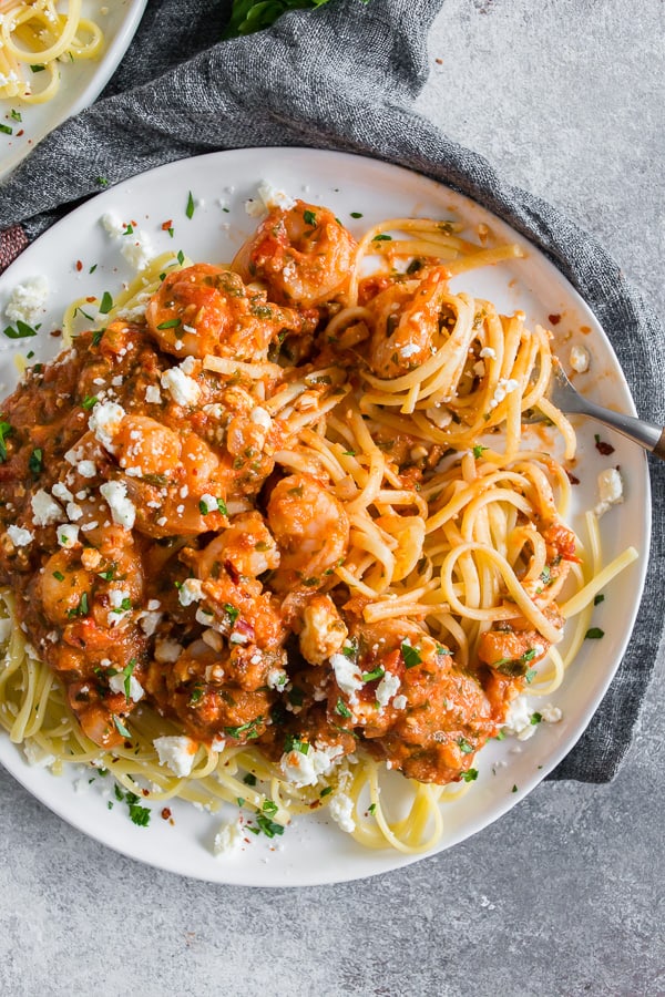 This pasta with shrimp and feta is a flavor-packed weeknight or special occasion meal. My husband grew up eating this dish and it's his all-time favorite. Garlicky shrimp mixed with a feta packed sherry tomato sauce served over perfectly cooked pasta - what's not to love? 