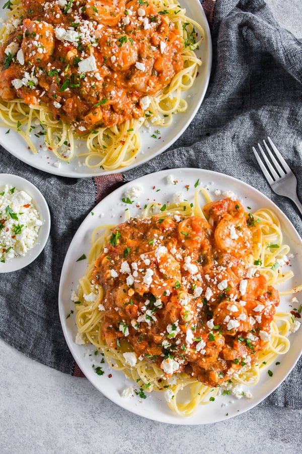 This pasta with shrimp and feta is a flavor-packed weeknight or special occasion meal. My husband grew up eating this dish and it's his all-time favorite. Garlicky shrimp mixed with a feta packed sherry tomato sauce served over perfectly cooked pasta - what's not to love? 