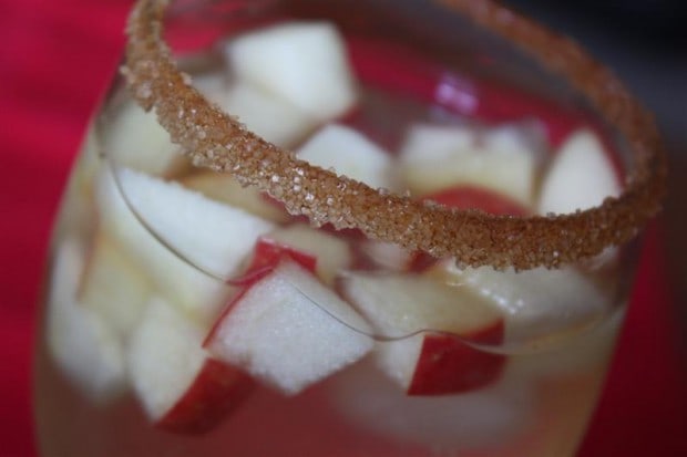 Honeycrisp Apple Sangria by Nutmeg Nanny Honeycrisp Apple Sangria in a glass with a cinnamon sugar rim.