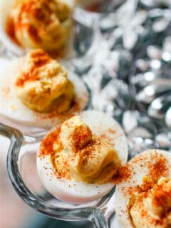 classic deviled eggs sitting on a glass dish