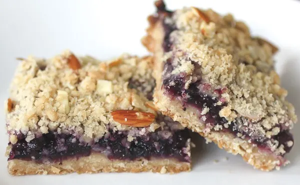 These blueberry crumb bars are packed full of fruity flavor and topped with a crumbly oat and nutty almond topping. Super simple to make and totally delicious.
