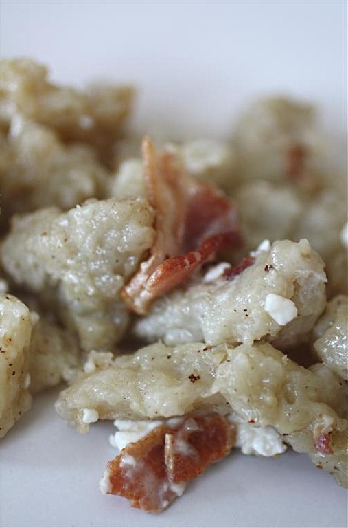 This homemade Slovak potato halusky is made with fresh potatoes and flour and fried with bacon and cottage cheese. It's Slovakian food at it's finest.