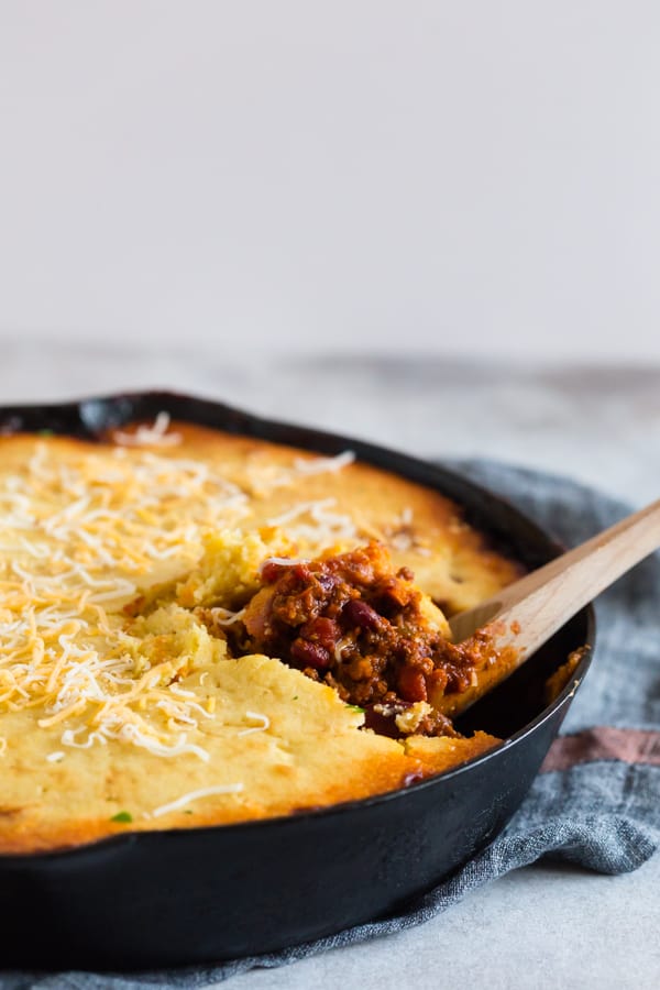 This buttermilk cornbread topped chili is the perfect combination of thick hearty chili and lightly sweetened cornbread. It's similar to a casserole and works perfectly when made in a giant cast iron skillet. You'll love this dish! 