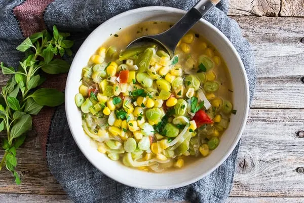 This super easy vegan and vegetarian succotash soup is packed full of lima beans, corn and fresh herbs. Ready in just 30 minutes and perfect for dinner or a light summer lunch. Trust me, you'll love this soup!