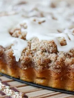 pumpkin coffee cake with brown butter glaze sitting on a pie plate