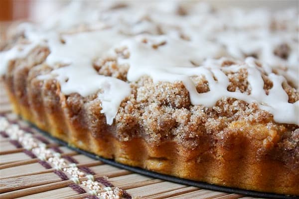pumpkin coffee cake with brown butter glaze sitting on a pie plate
