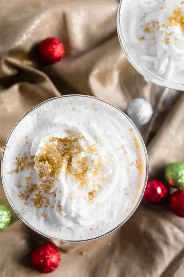 Gingerbread Martini in a glass topped with whipped cream. 