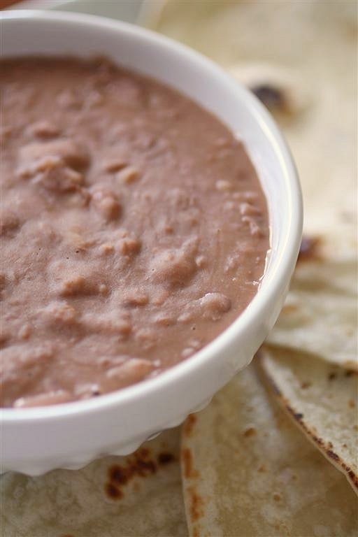 These Southern style pinto beans only take 4 ingredients and cost less than $5 to make! They are perfect eaten plain or rolled up in a soft flour tortilla.
