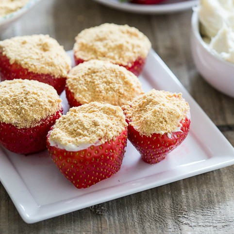 These no-bake cheesecake stuffed strawberries are simple to make and perfect for Valentine's Day. Stuffed with sweet cream cheese filling and topped with a dusting of graham cracker crumbs.