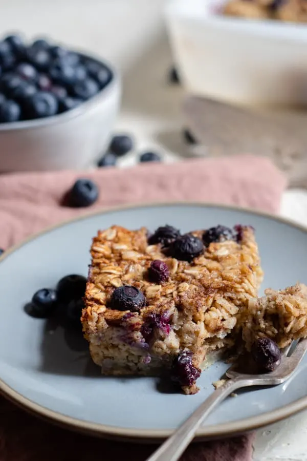 baked blueberry oatmeal on a plate with a fork