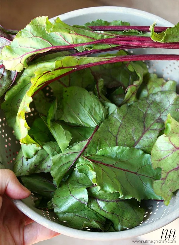 Beet greens in a strainer. 
