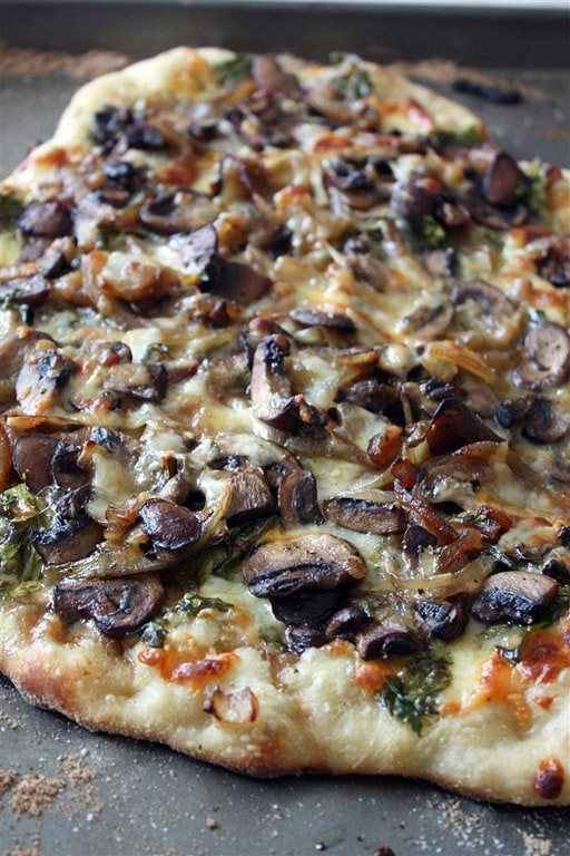 This caramelized onion mushroom and lambs quarters pizza are packed full of flavor and seasonal ingredients. If you can't find lambs quarters try arugula or spinach. 