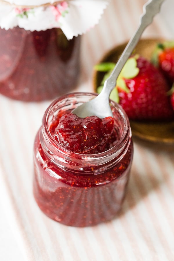 a little spoon inside a jar of vanilla bean strawberry jam