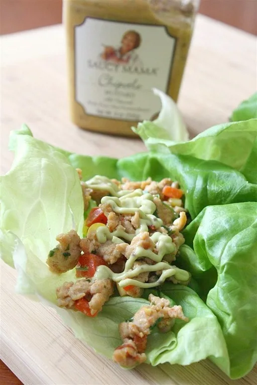 These chipotle chicken lettuce cups are the perfect lunch or dinner. Delicious ground chicken jazzed up with chipotle peppers, spicy brown mustard, red bell peppers, and corn all wrapped up in crunchy bibb lettuce leaves. Then to top it off it's drizzled with avocado sour cream. 