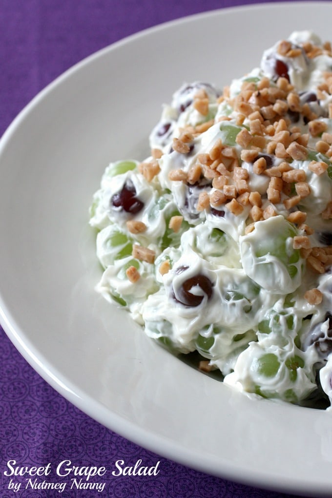 sweet grape salad in a bowl sprinkled with toffee bits. 