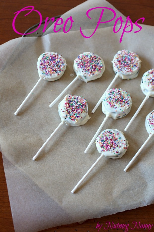 Oreo Pops sitting on parchment paper. 