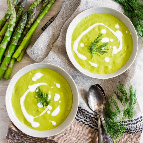 overhead shot of Cream of Roasted Asparagus Soup in bowls