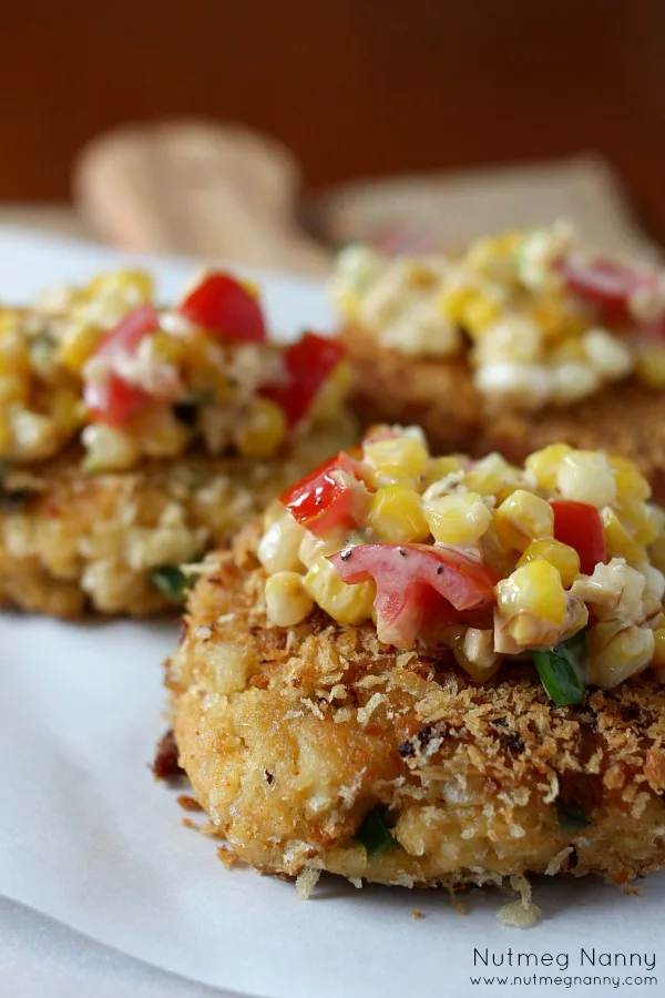 These crab cakes with sweet corn salsa are the perfect summer appetizer or main course. Made with jumbo lump crab and topped with lots of summer vegetables.