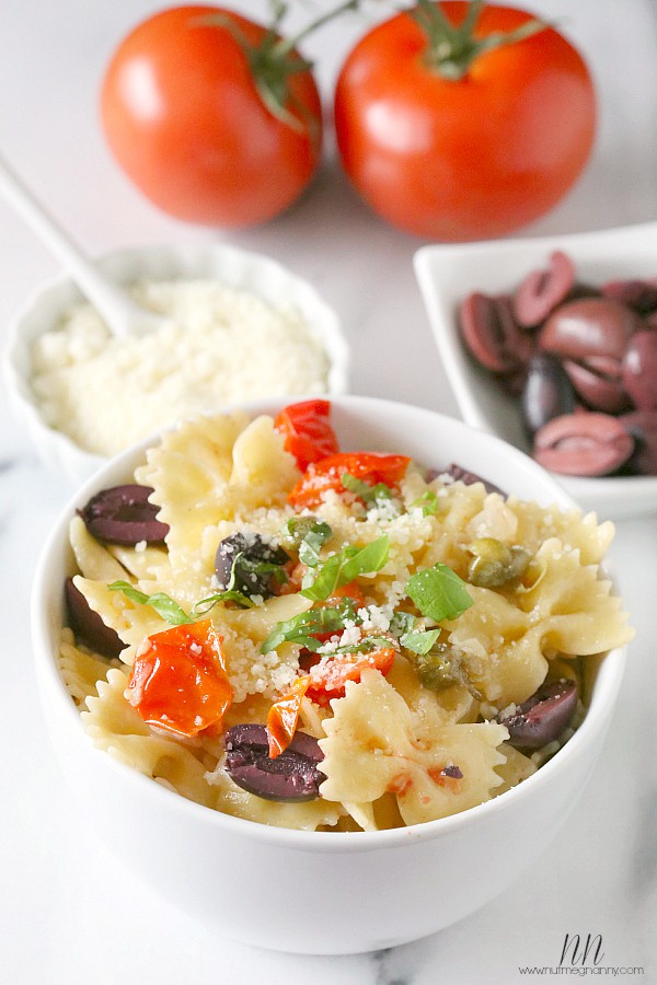 Kalamata Olive, Tomato and Caper Pasta in a white bowl. 