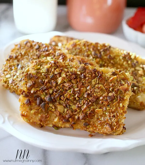 This pistachio crusted angel food cake French toast is perfectly sweet and has just the right amount of nut crunchiness. Drizzle with honey and devour.