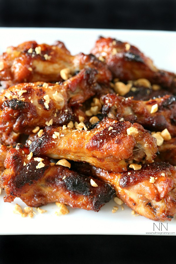 peanut butter and jelly chicken wings topped with chopped peanuts
