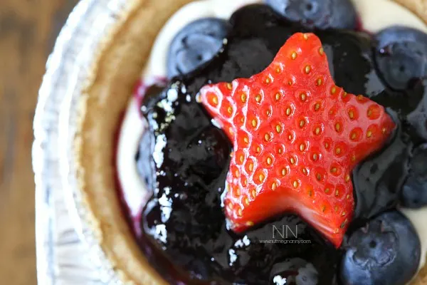 No Bake Blueberry Cheesecake topped with a star shaped strawberry. 