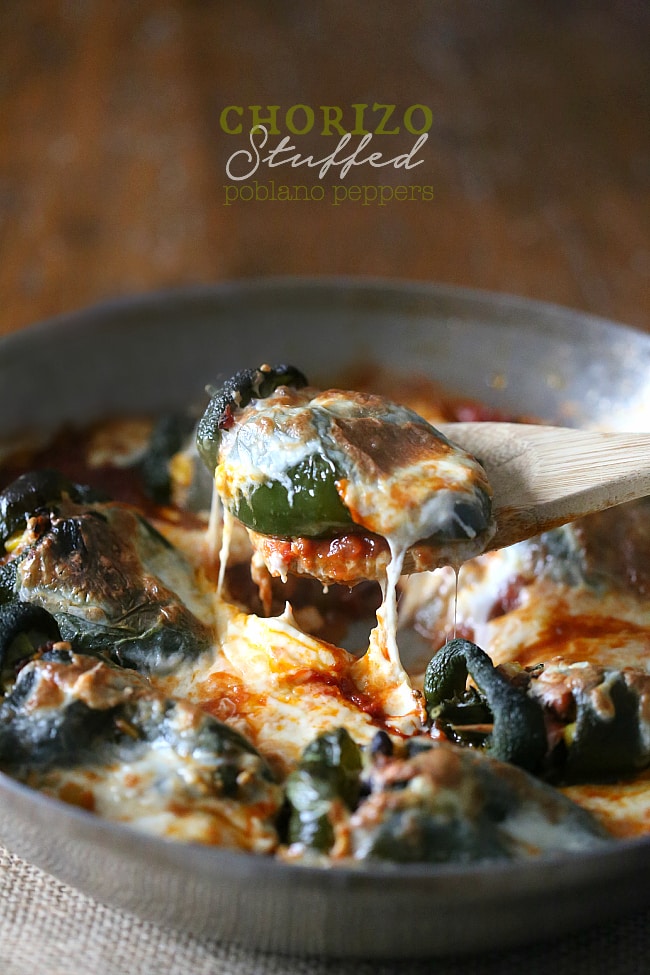 These chorizo stuffed poblano peppers are packed full of spicy chorizo, black beans, sweet corn, oaxaca cheese and baked in a flavorful tomato sauce. If you're looking for a new version of stuffed peppers this is the perfect version! Chorizo Stuffed Poblano Peppers in a pan.