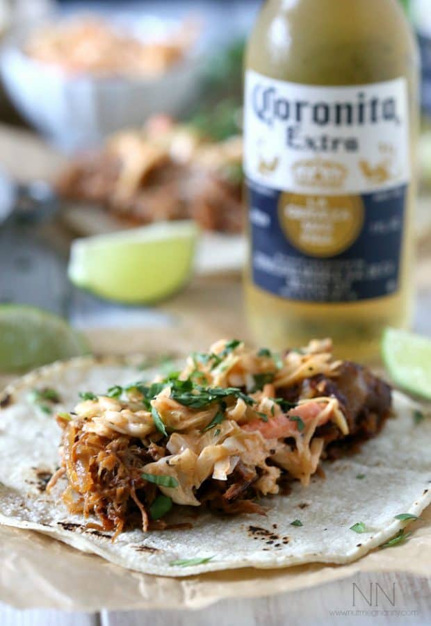 These slow cooker ginger beer pulled pork tacos are topped with a spicy chipotle cole slaw and served on toasted corn tortillas. 