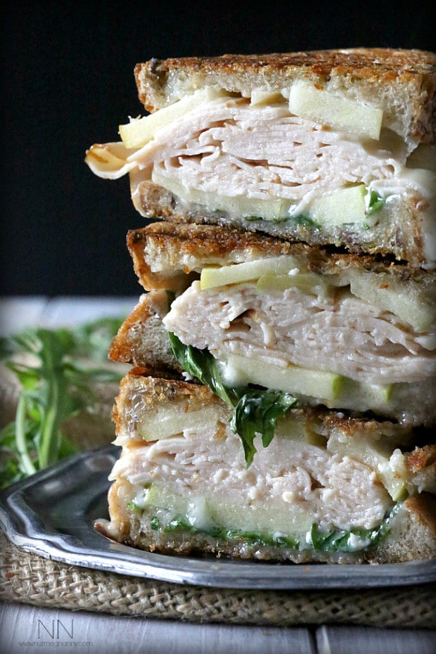 Turkey Apple Brie Panini cut in half to show all the layers. 