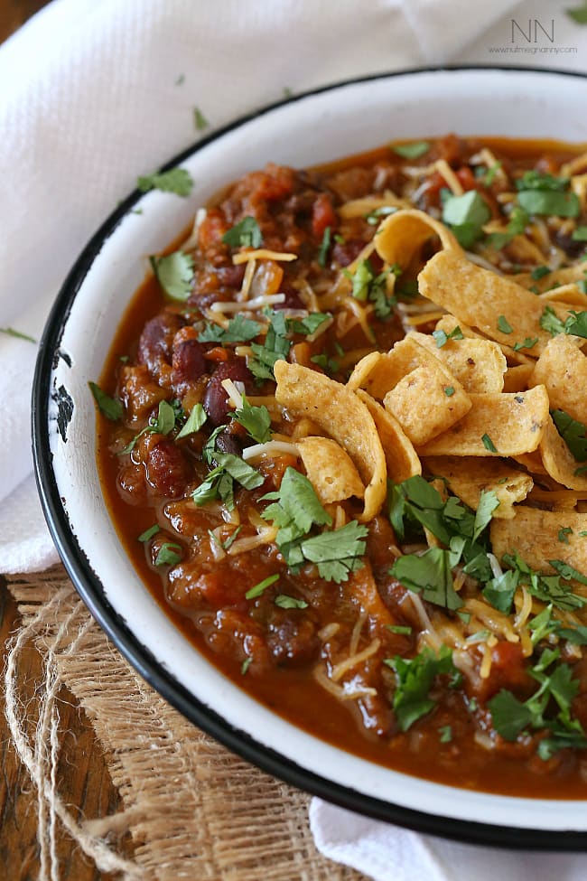 This slow cooker pumpkin chili is packed full of pumpkin puree, spicy Italian sausage and lots of beans and vegetables. This hearty soup is perfect for cold winter nights.