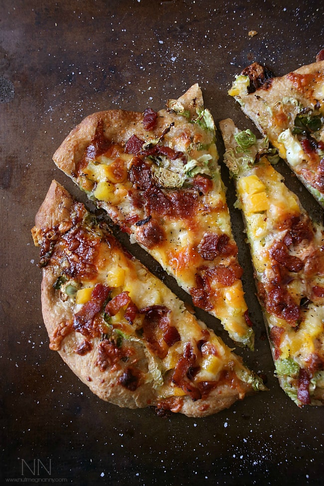 This bacon brussels sprouts butternut squash flatbread is packed full of autumnal flavor and cheesy cheddar cheese. Super simple to make and ready in just 20 minutes.