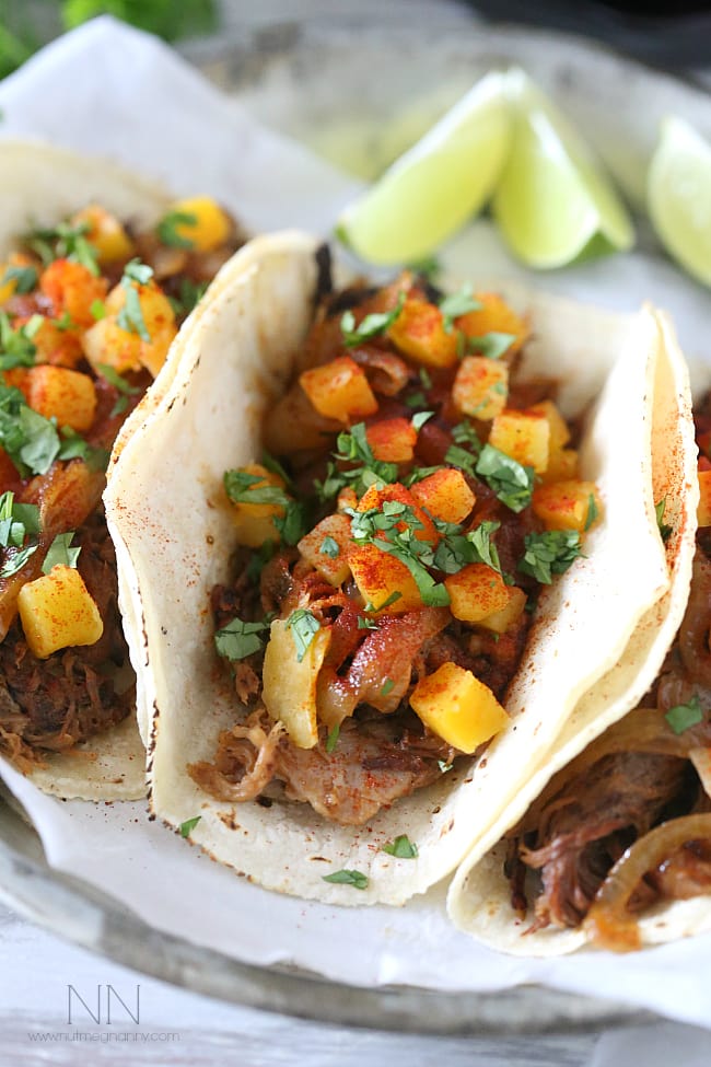These chipotle apple butter carnitas are topped with apple cider sautéed onions and spiced butternut squash. This is one pork dish you will be craving!
