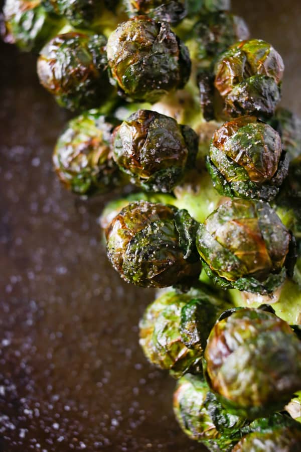 up close photo of on the stalk roasted brussels sprouts