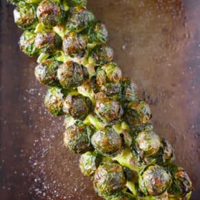 on the stalk roasted Brussels sprouts on a sheet pan