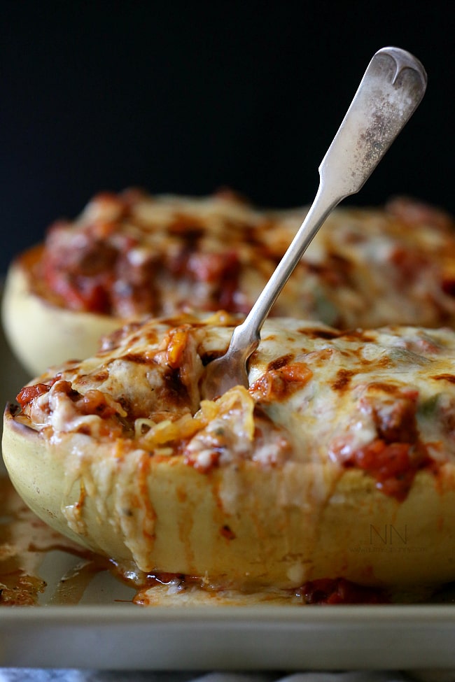 Sausage and Peppers Stuffed Spaghetti Squash with a fork in it. 