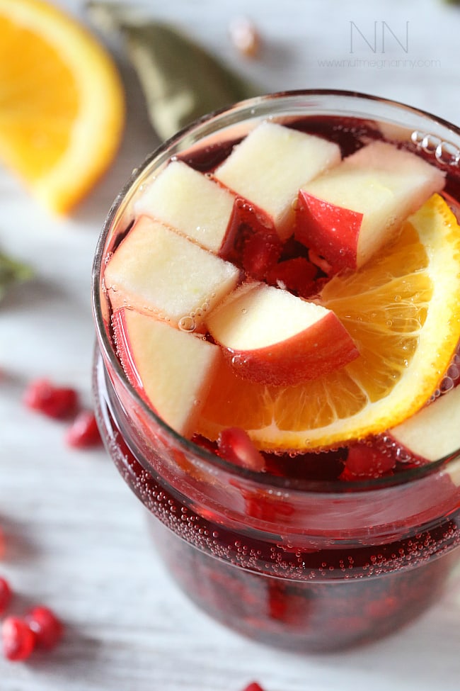 Thanksgiving Cocktails - This simple Thanksgiving sangria is packed full of pomegranate seeds, apple, orange and semi sweet red wine. This drink is perfect for your holiday table.