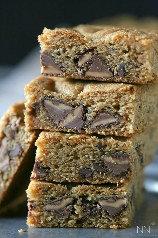 These peanut butter stuffed chocolate chip cookie bars are bursting with lots of peanut butter deliciousness. Serve warm with a big glass of cold milk.
