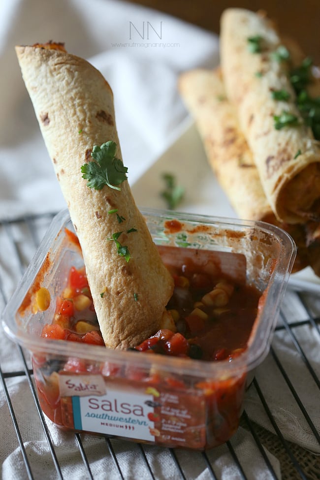 Creamy Chicken Taquitos dipped in salsa. 