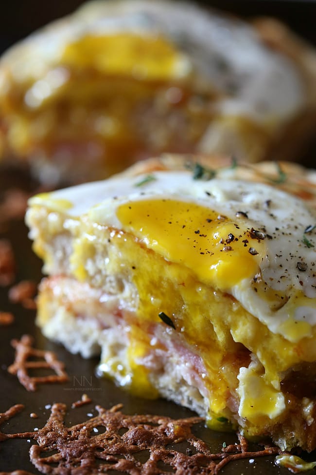 This croque madame is the perfect combination of bechamel cheese sauce, Canadian bacon and Swiss cheese stuffed between two slices of crusty bread and topped with a fried egg. Perfect for breakfast or dinner.
