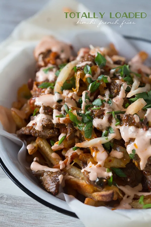 These totally loaded kimchi fries are the perfect flavor packed appetizer or main course. Crispy fries topped with melted cheese, seasoned beef and sautéed kimchi.