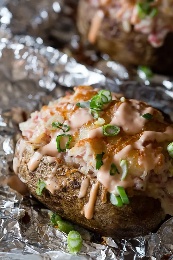 Twice Baked Stuffed Reuben Potatoes drizzled with russian dressing. 