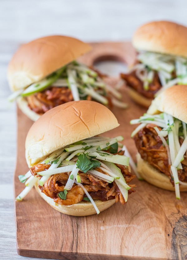 This apple butter bbq chicken sandwich is made with a homemade apple butter bbq sauce, roasted chicken breast and topped with a tangy tart apple cilantro slaw.