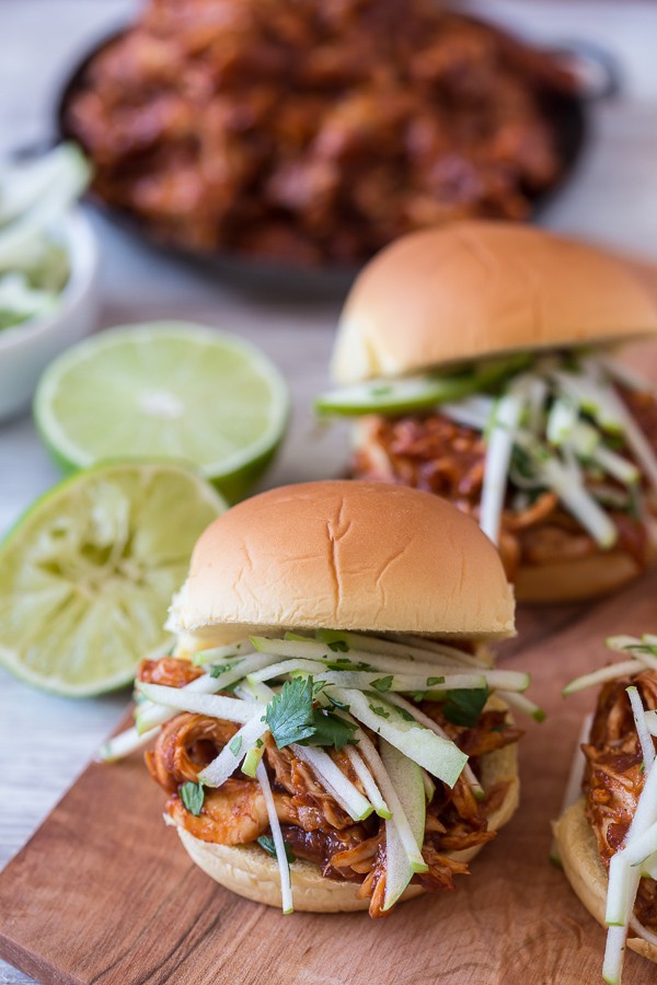 This apple butter bbq chicken sandwich is made with a spicy homemade apple butter bbq sauce, roasted chicken breast and topped with a tangy apple cilantro slaw.