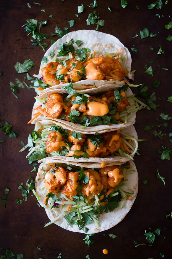 Four chipotle shrimp tacos drizzled with gochujang mayonnaise and fresh cilantro. 