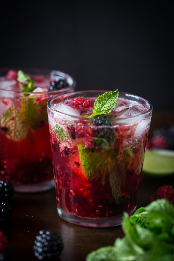 mixed berry mojito is a glass topped with mint. 