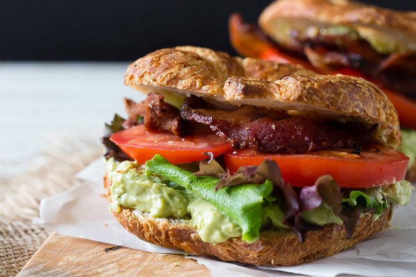 This creamy avocado egg salad BLT is the perfect spring sandwich. Hard boiled eggs and creamy avocado pilled high on a croissant with bacon, lettuce and tomato.